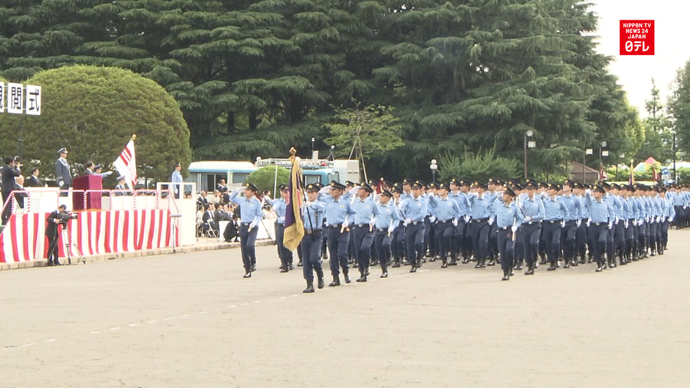 Riot police march in Meiji Shrine