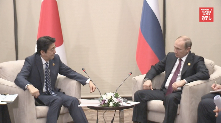 Abe, Putin agree to delay Putin visit