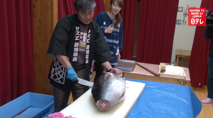 Kids shown how to carve a tuna 
