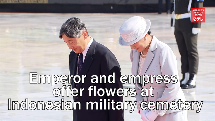 Japanese emperor and empress offer flowers at Indonesian military cemetery