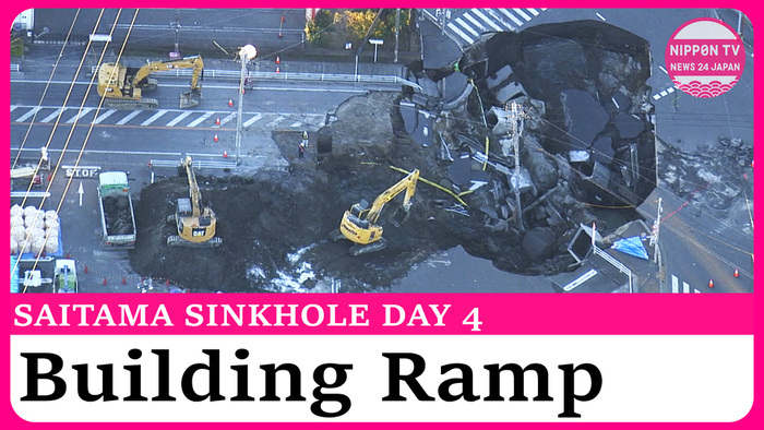 Workers building ramp to rescue truck driver trapped in sinkhole north of Tokyo