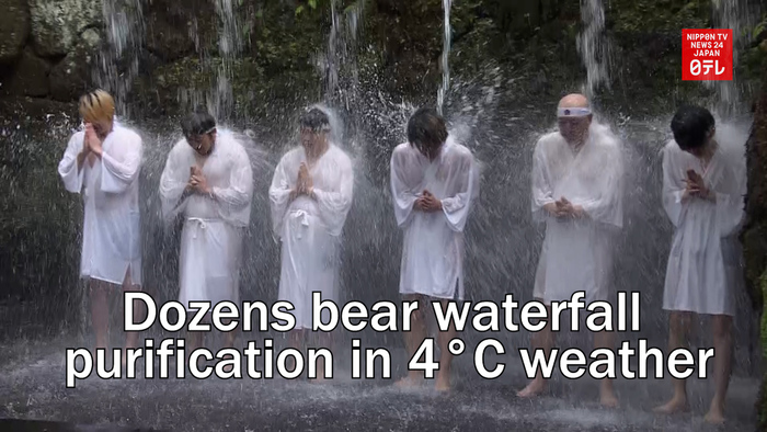 Dozens bear waterfall purification in 4 degrees weather