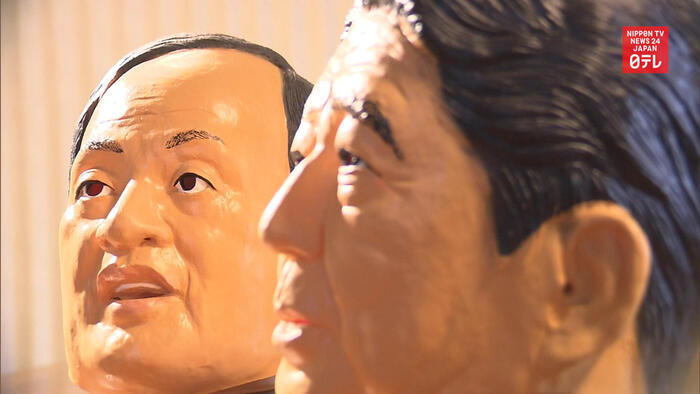 Post-Abe PM contender Suga gets own mask