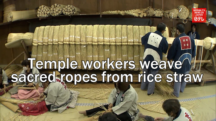 Temple workers weave sacred ropes from rice straw