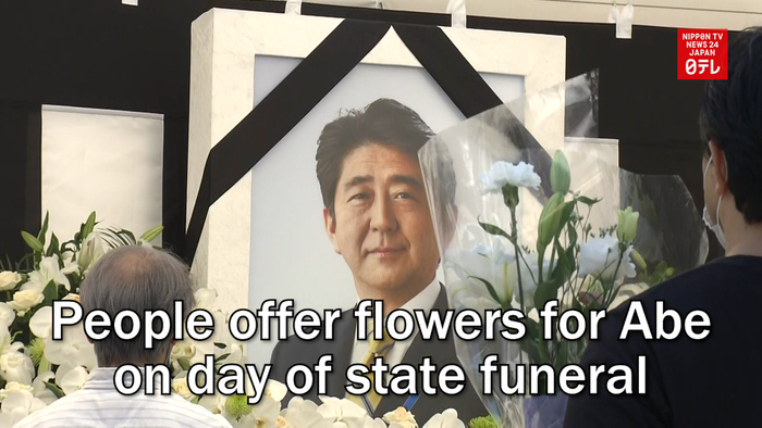 People offer flowers for Abe on day of state funeral
