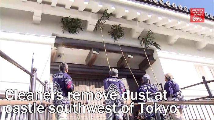 Cleaners remove dust at castle southwest of Tokyo