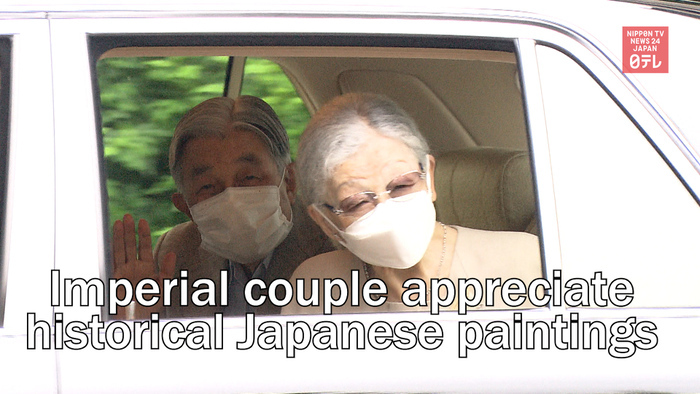 Emperor Emeritus Akihito and Empress Emerita Michiko contemplate historical Japanese paintings