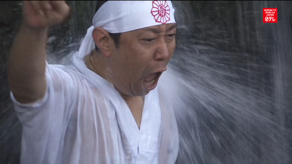 Devotees brave freezing waterfall