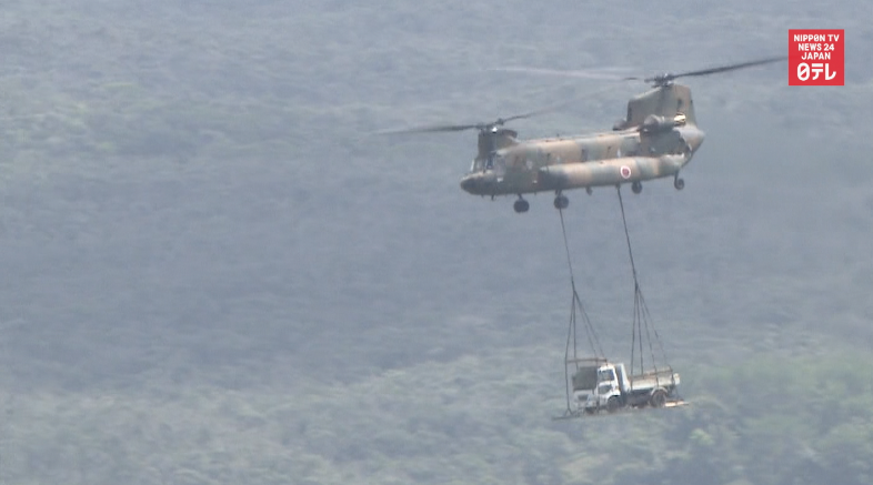 Helicopters airlift trucks as protesters block road