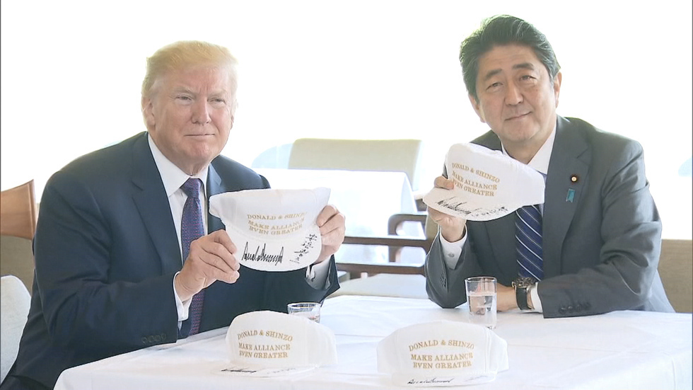 Trump and Abe talk North Korea on the green