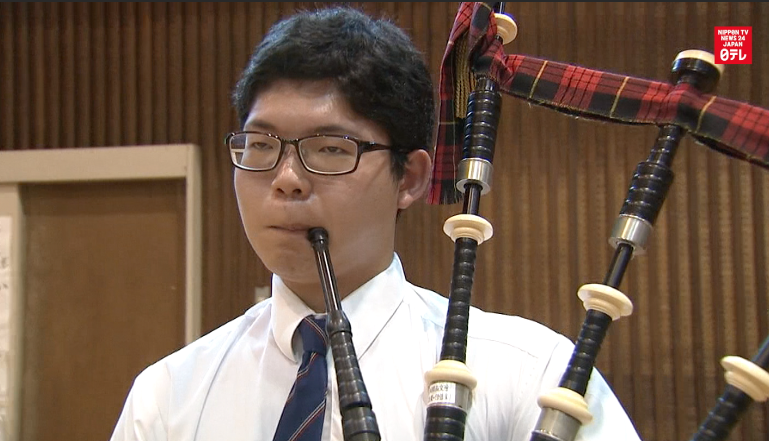 Bagpipe boys walk lonely road