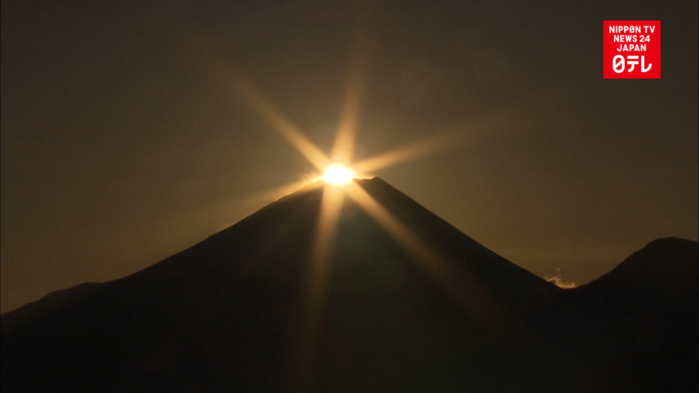 Sunrise over the top of Mt. Fuji charms photographers