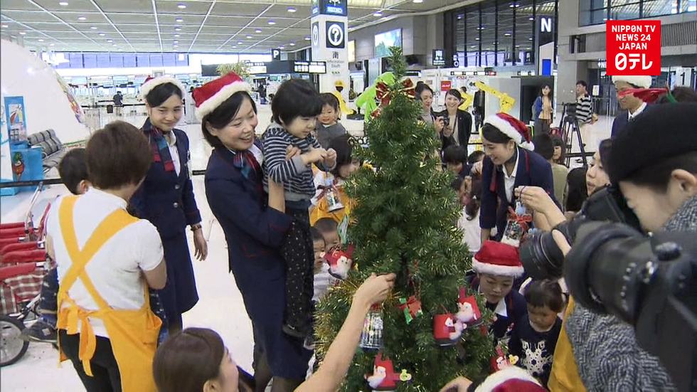 Children decorate tree at Narita Airport